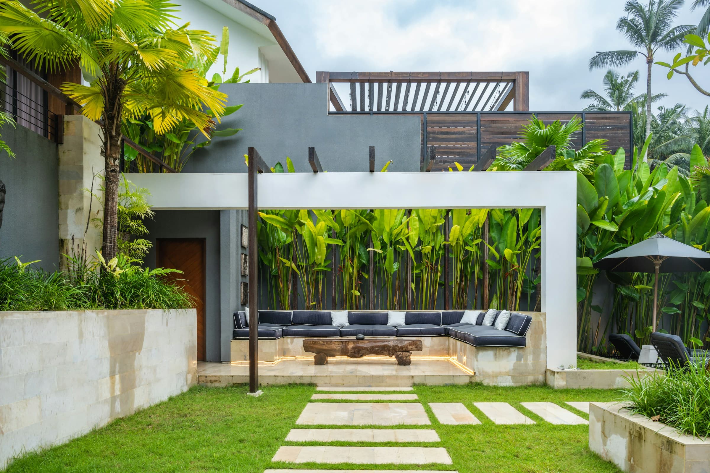 Stone terrace with built-in seating, natural stone garden walls and paved walkway